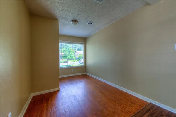 a view of an empty room and wooden floor