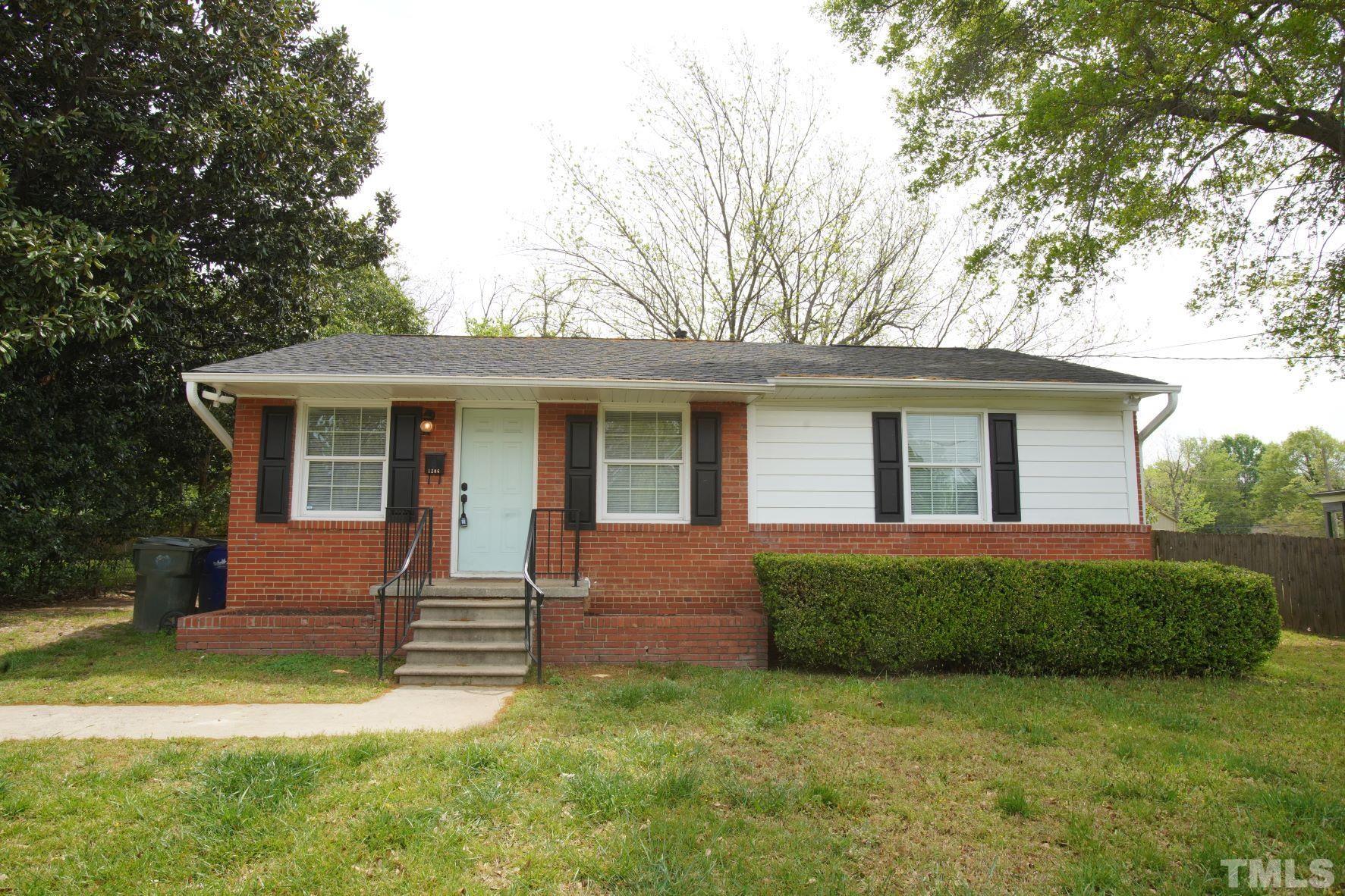 1206 Downing Road Raleigh, NC 27610 - Photo 1 of 15 front view of a house and a yard