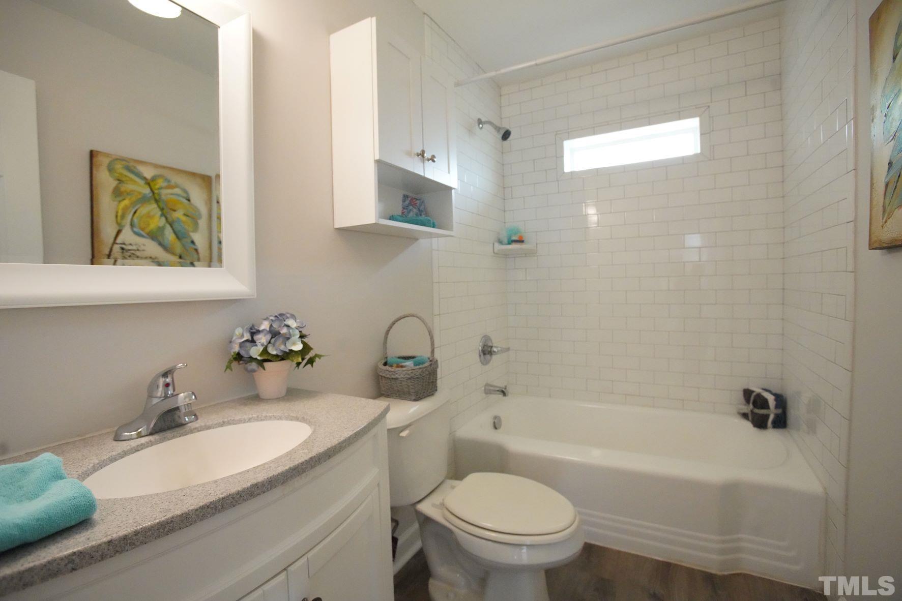1206 Downing Road Raleigh, NC 27610 - Photo 11 of 15 a bathroom with a sink a toilet and bathtub