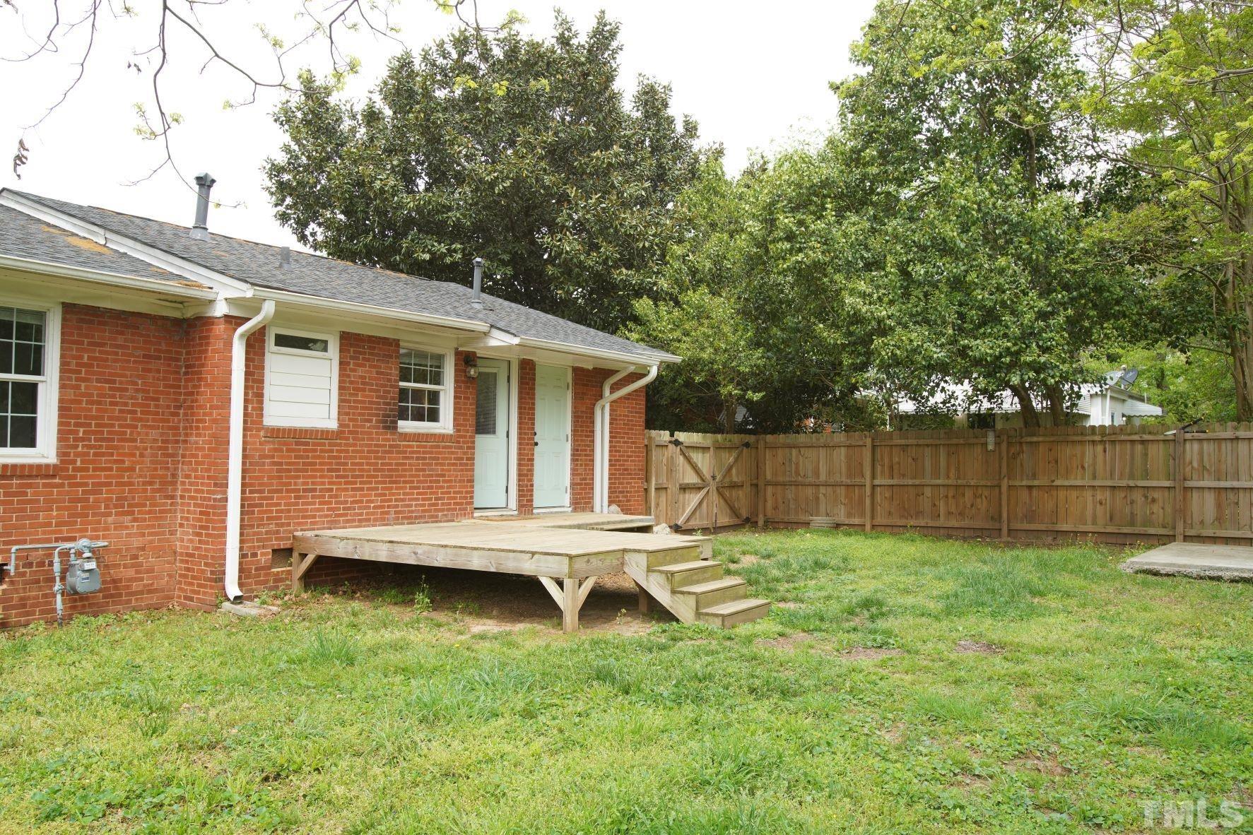 1206 Downing Road Raleigh, NC 27610 - Photo 13 of 15 a backyard of a house with lots of green space