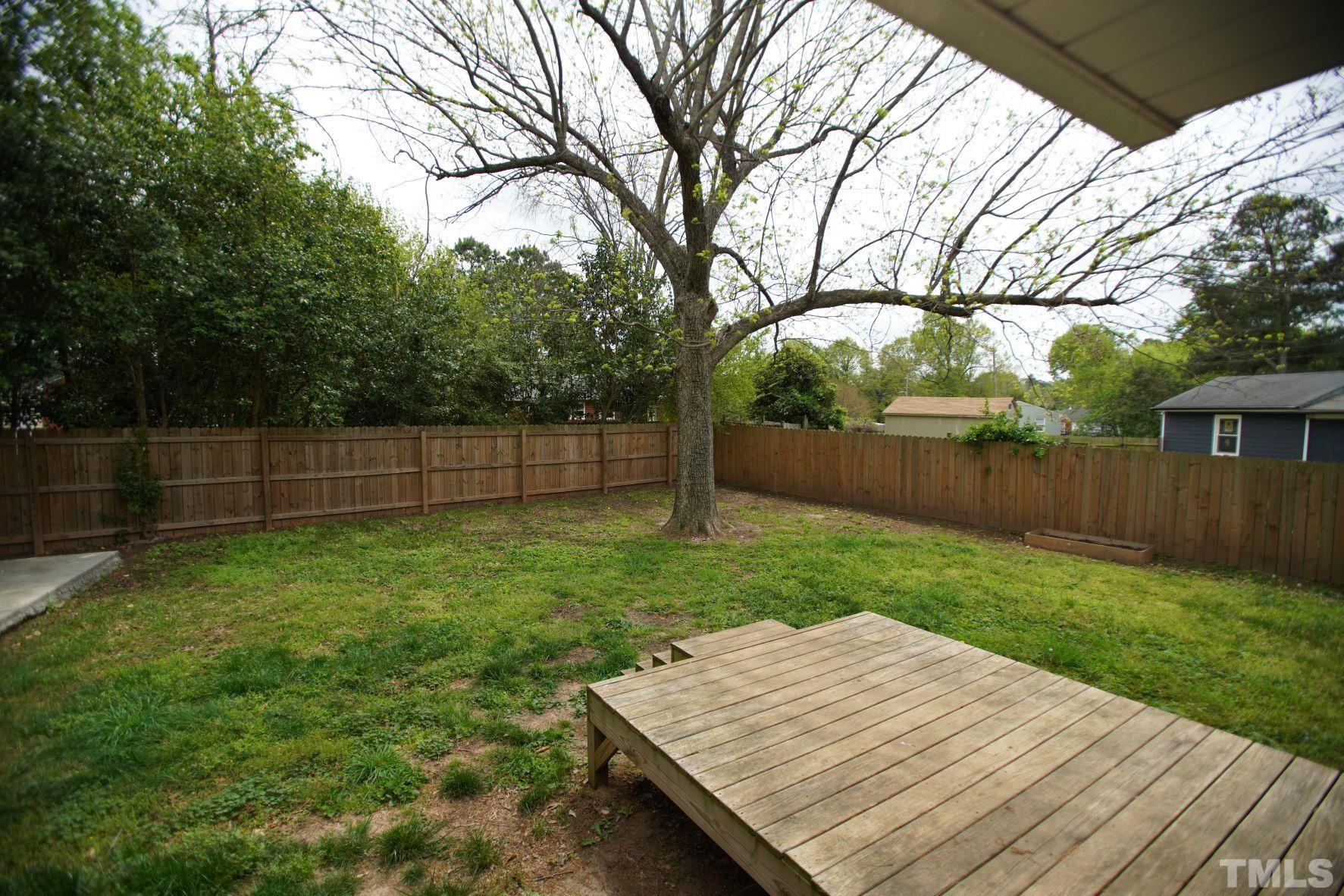 1206 Downing Road Raleigh, NC 27610 - Photo 14 of 15 a wooden bench sitting in the middle of a yard