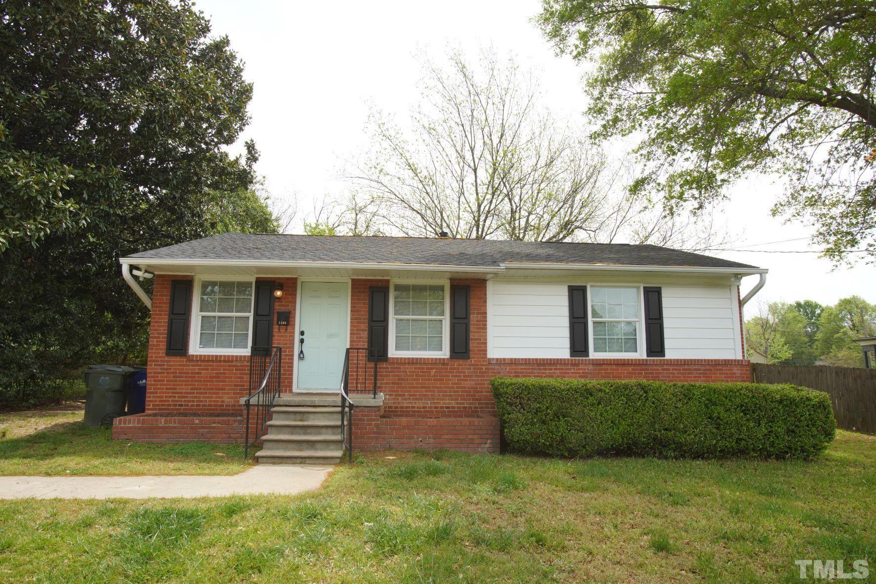 1206 Downing Road Raleigh, NC 27610 - Photo 2 of 15 a front view of a house with a yard and garage