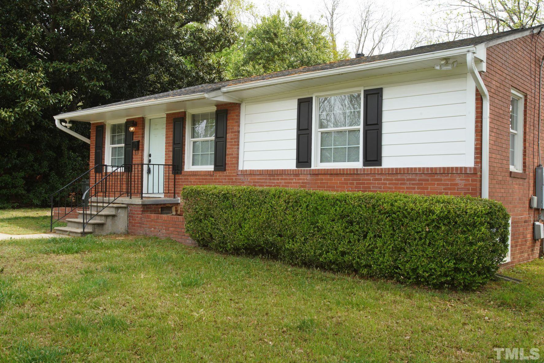 1206 Downing Road Raleigh, NC 27610 - Photo 3 of 15 a front view of a house with a garden