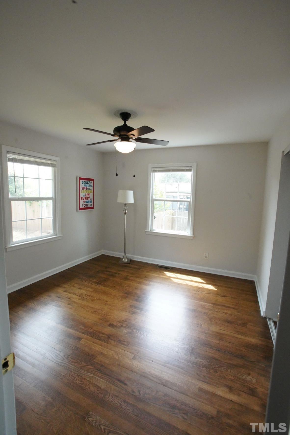 1206 Downing Road Raleigh, NC 27610 - Photo 9 of 15 a view of an empty room with wooden floor and a window