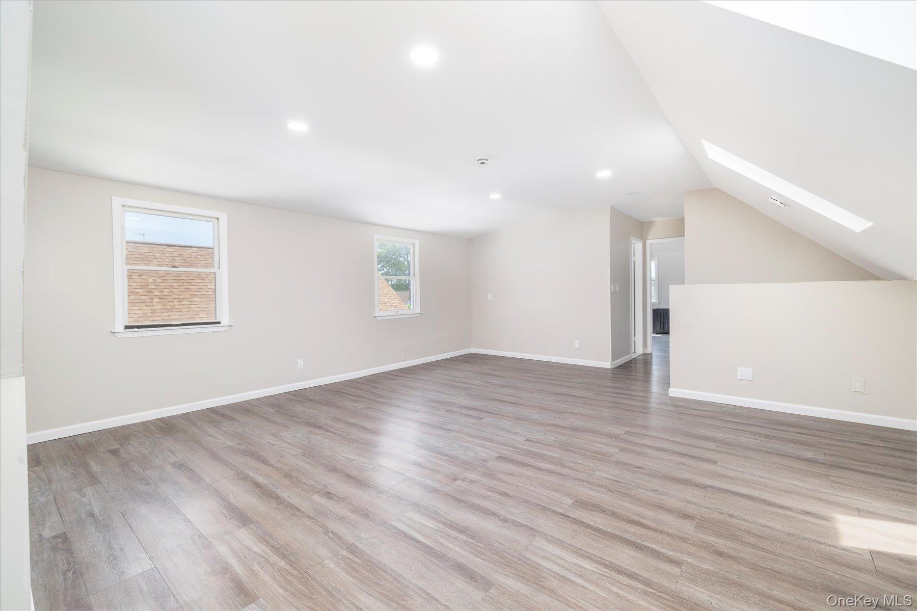 191 Raff Avenue Mineola, NY 11501 - Photo 23 of 25 a view of an empty room with wooden floor and a window
