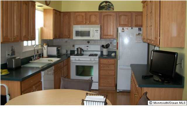 17 Brooke Road Brick, NJ 08724 - Photo 2 of 3 a kitchen with stainless steel appliances a stove a sink a refrigerator and cabinets