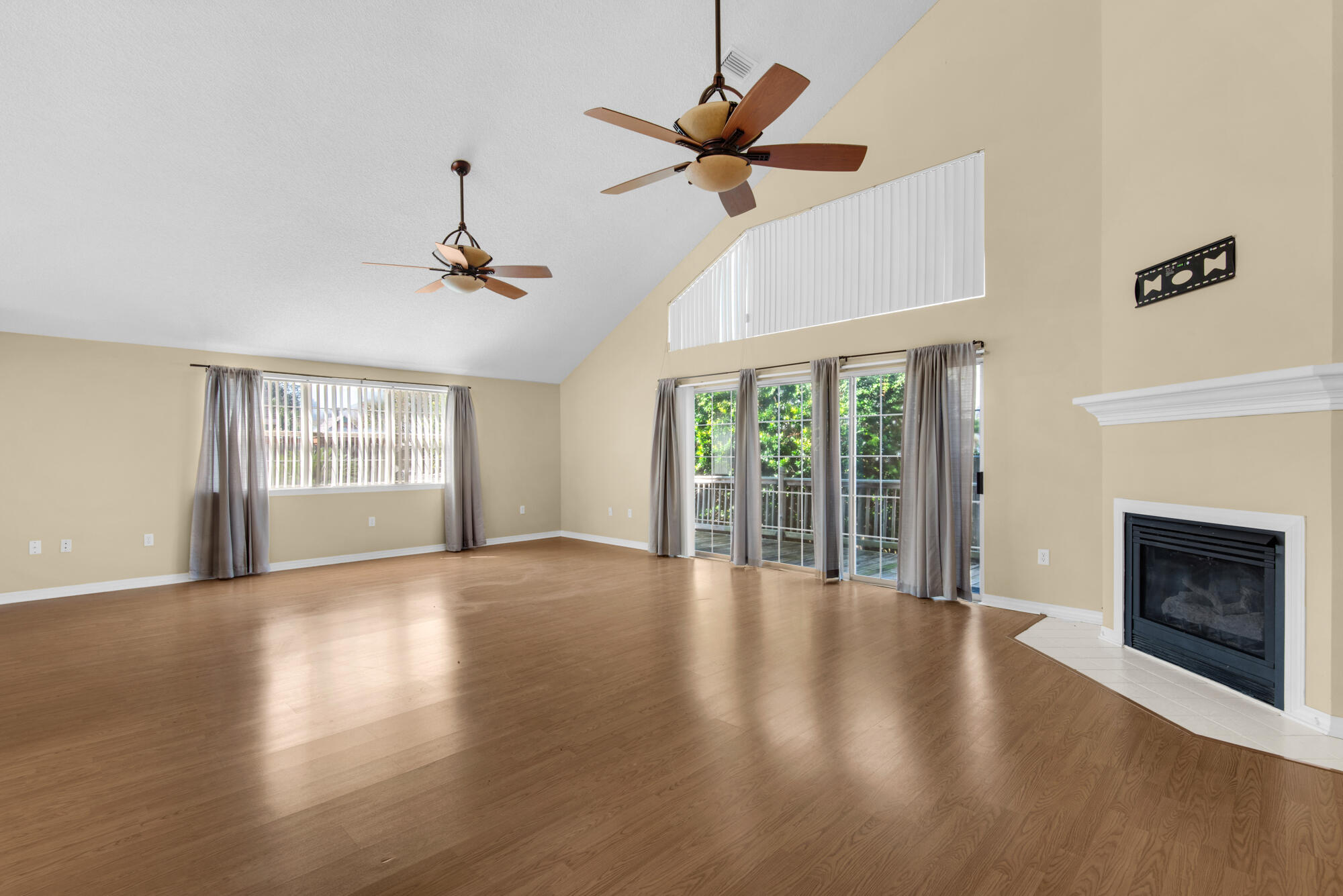 880 Brande Court Shalimar, FL 32579 - Photo 12 of 57 a view of an empty room with wooden floor and a window