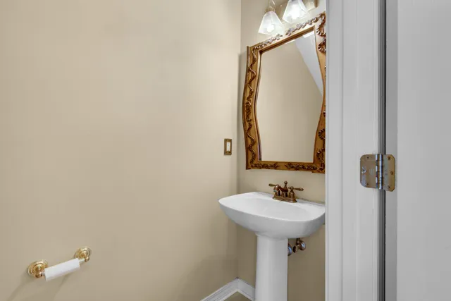 an empty room with a chandelier fan and windows