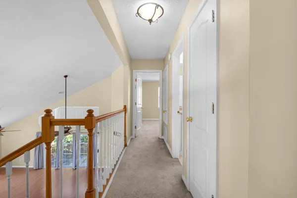 an empty room with closet and fan