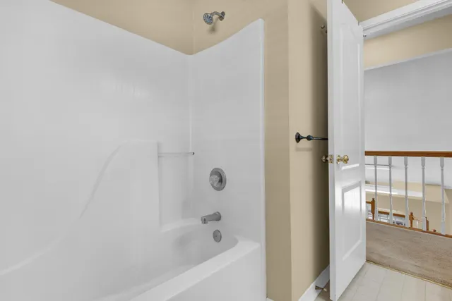 a view of a yard in front of a house with plants and a yard