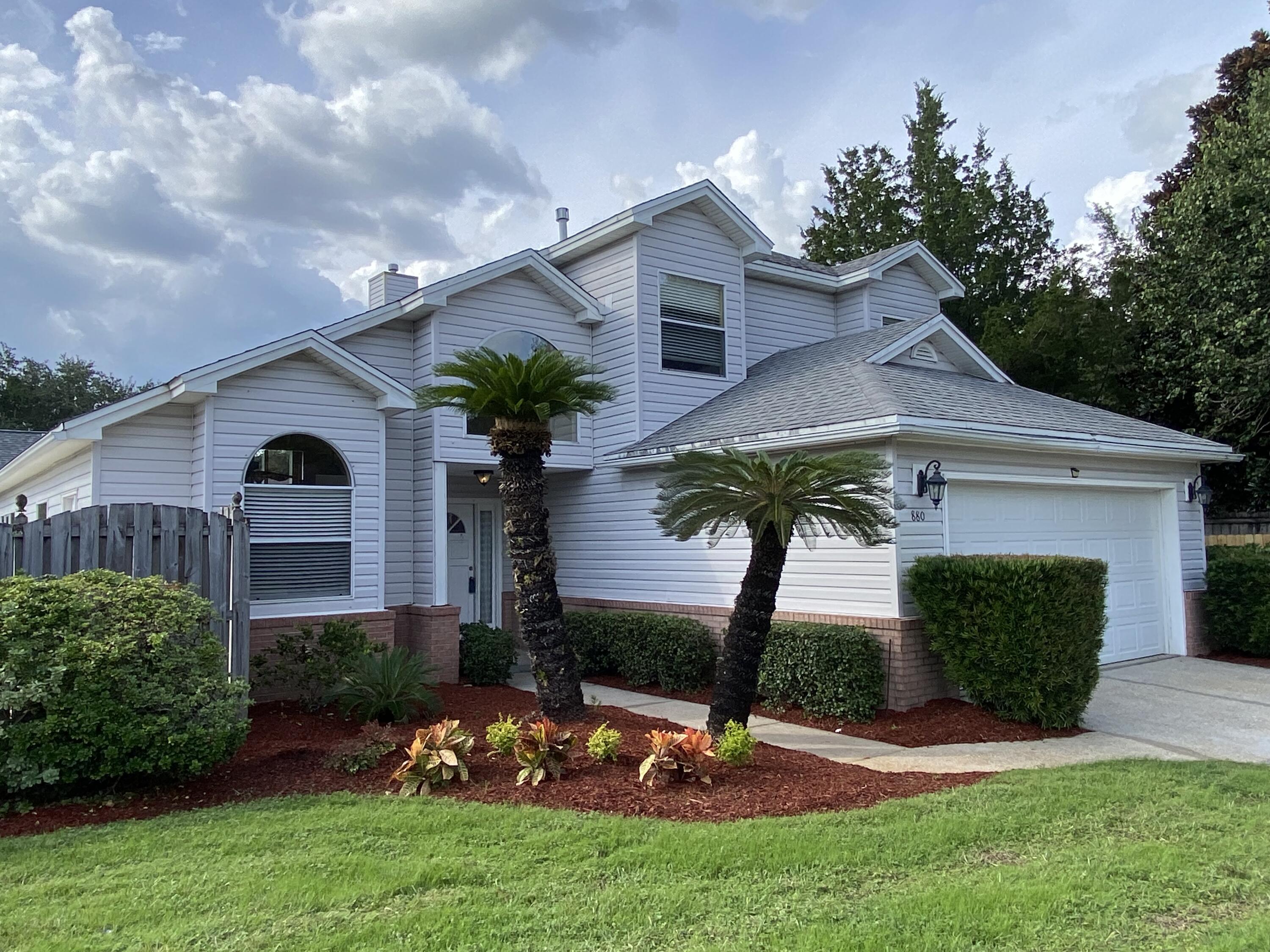 880 Brande Court Shalimar, FL 32579 - Photo 38 of 57 a view of a yard in front of a house with plants and a yard