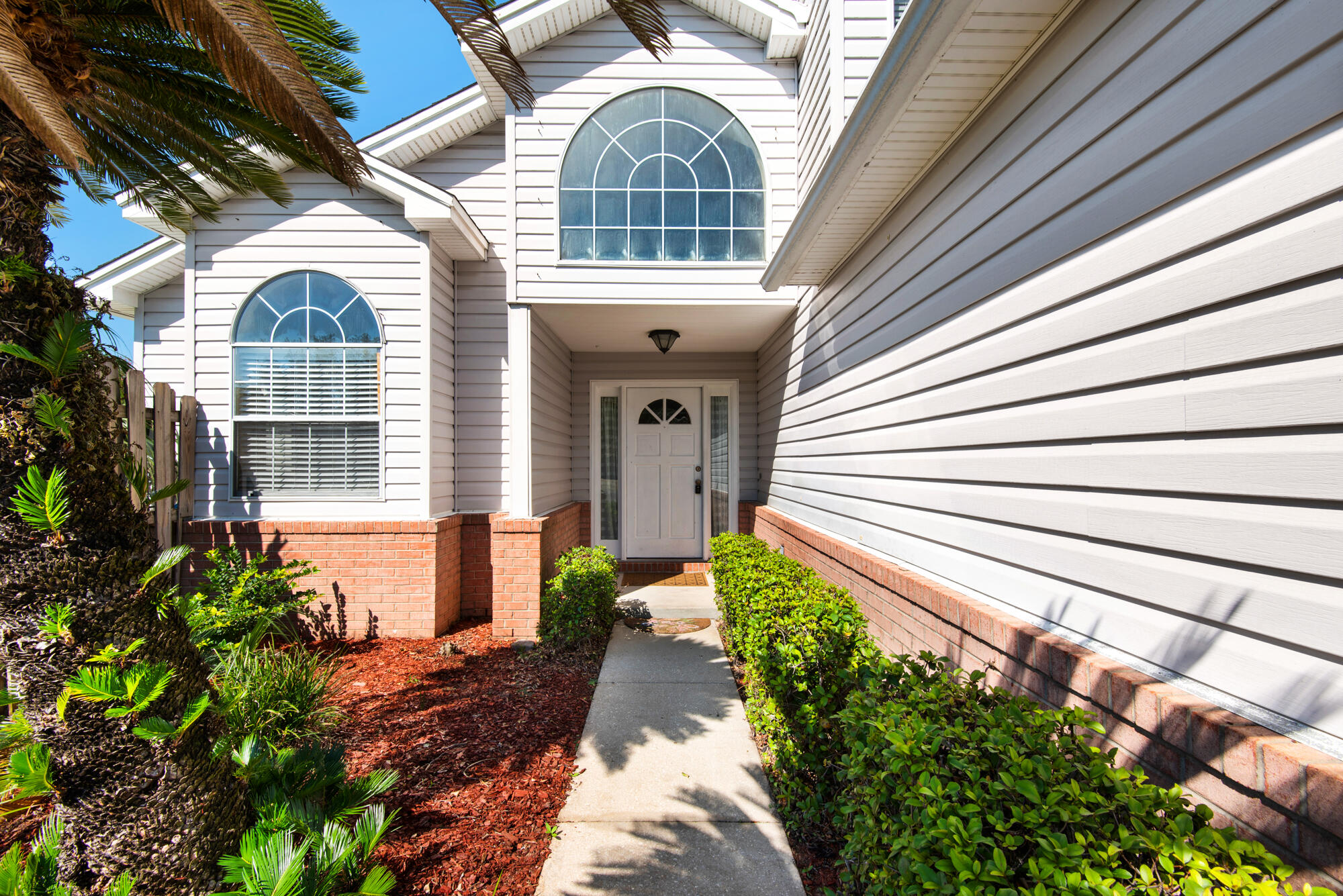880 Brande Court Shalimar, FL 32579 - Photo 4 of 57 a front view of a house with garden