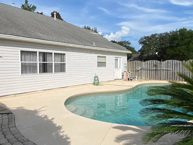 a view of a backyard with pathway
