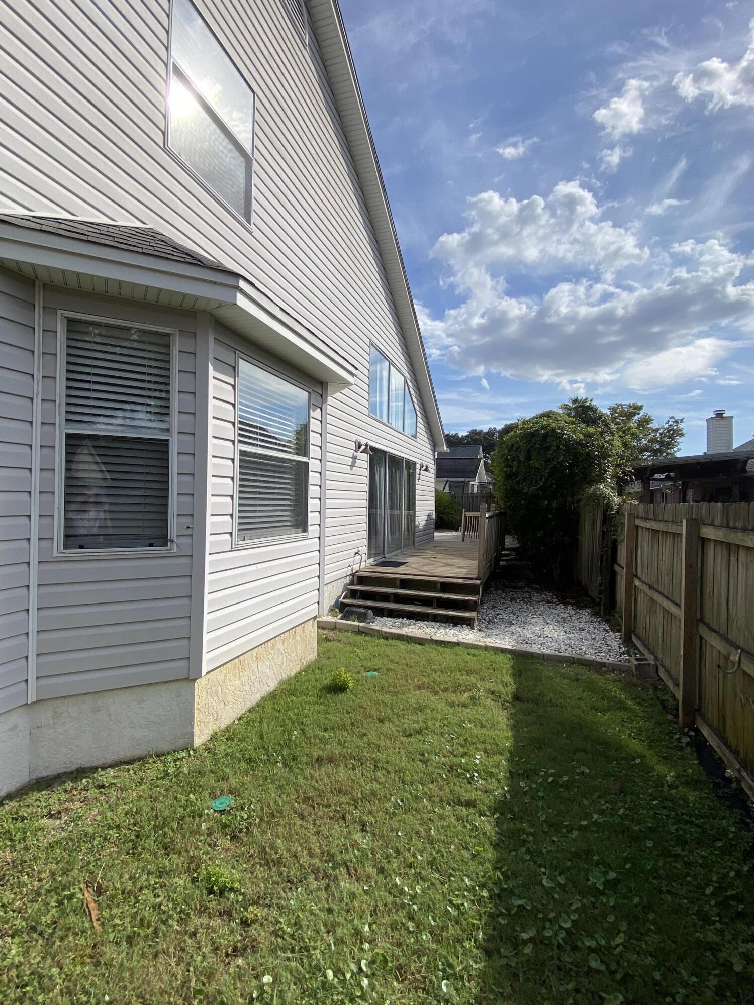 880 Brande Court Shalimar, FL 32579 - Photo 50 of 57 a view of a house with backyard and sitting area