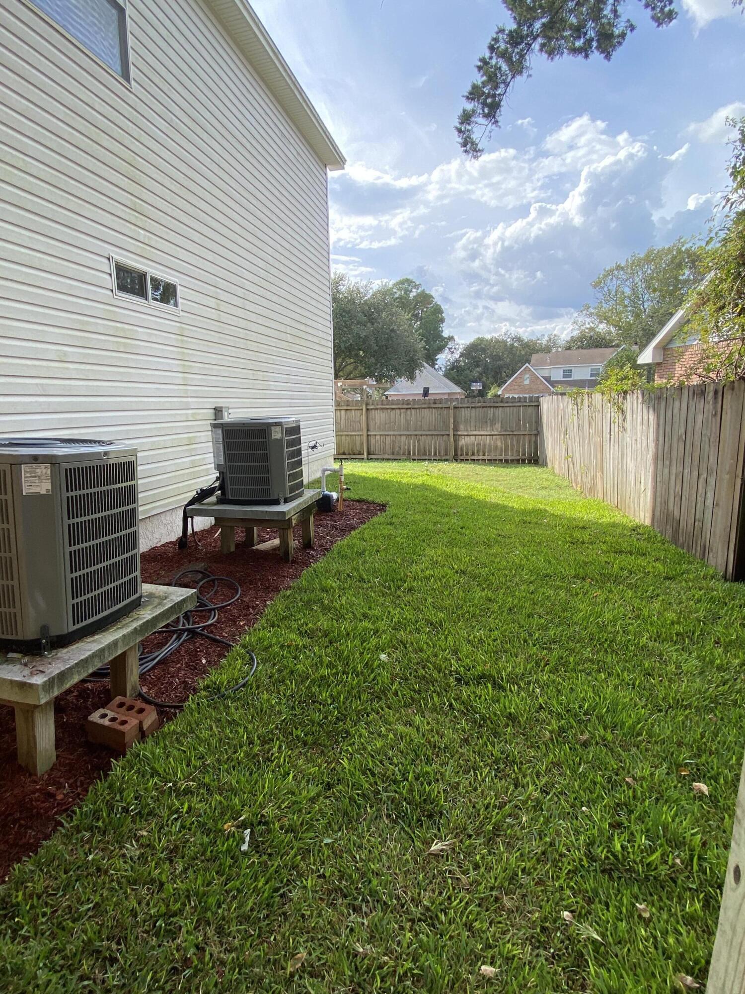 880 Brande Court Shalimar, FL 32579 - Photo 51 of 57 a view of a backyard with couches plants and wooden fence