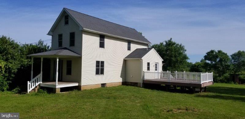 Farm House from rear yard facing back porch deck