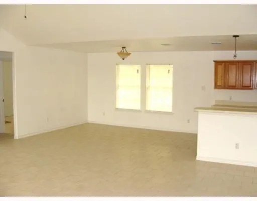 a view of an empty room and a window