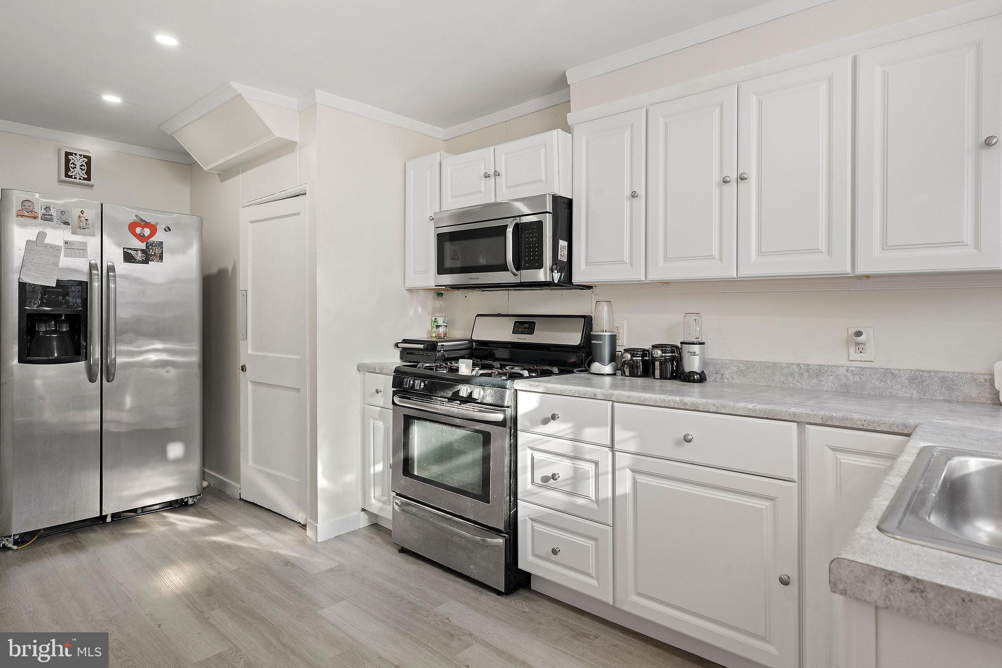 2907 North Constitution Road Camden, NJ 08104 - Photo 16 of 30 a kitchen with stainless steel appliances granite countertop a refrigerator and a stove top oven