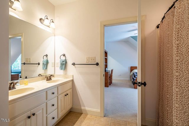 a bathroom with a double vanity sink toilet and shower