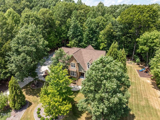 an aerial view of a house with yard