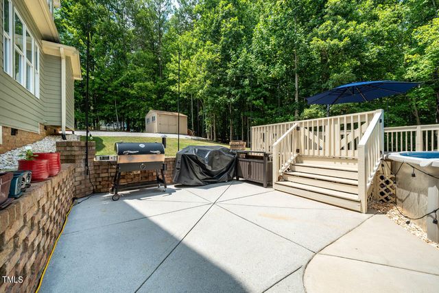 a view of a chairs and tables in the back yard of the house