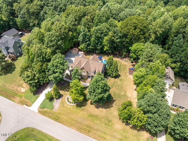 an aerial view of a house with a yard and garden