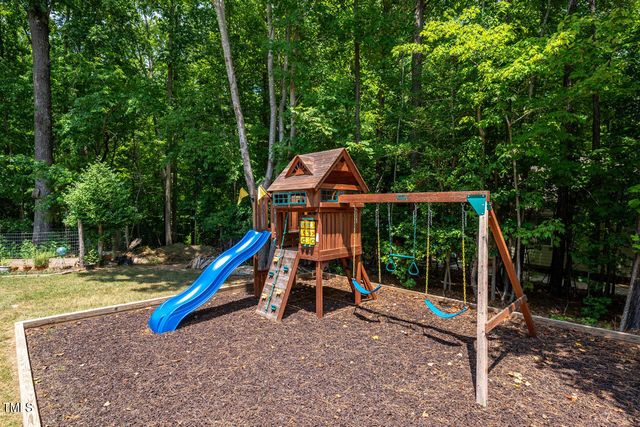 a view of a chair and fire pit in the backyard