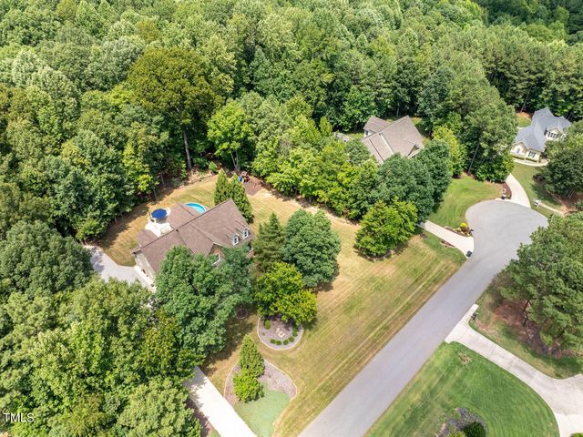 an aerial view of a house with outdoor space and street view