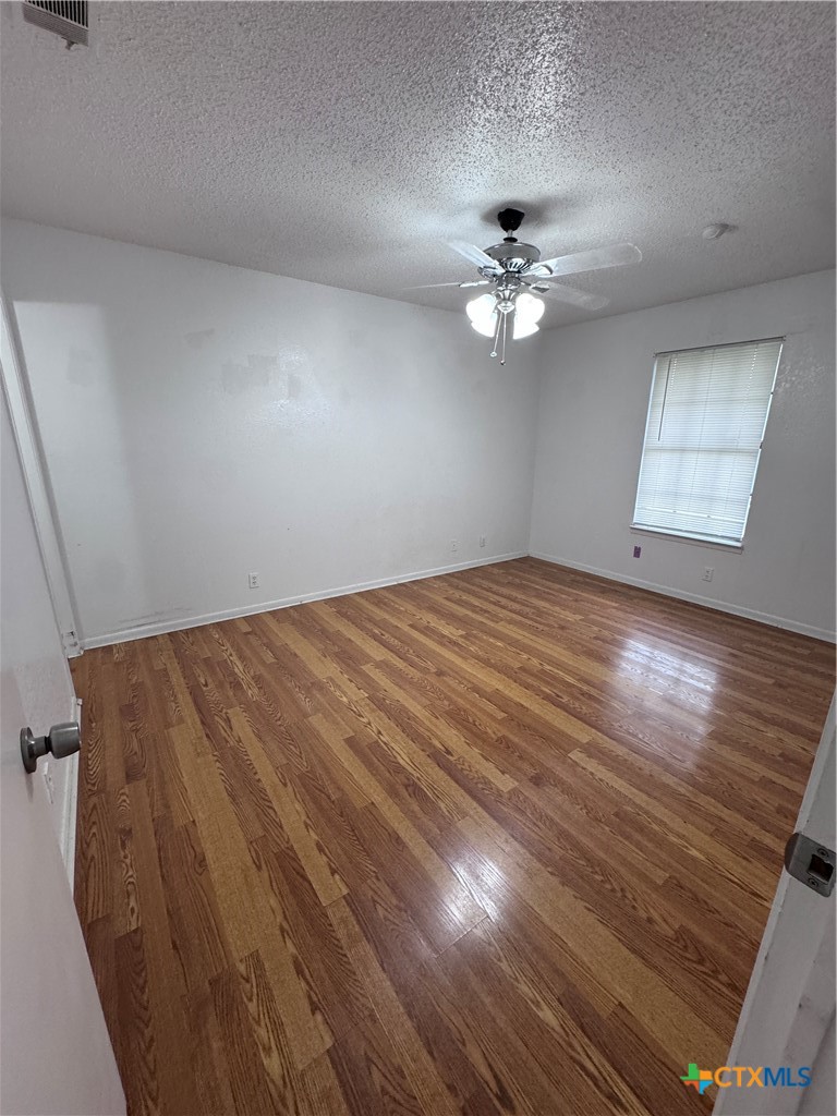 1301 North 10th Street Temple, TX 76501 - Photo 15 of 25 wooden floor in an empty room with a window