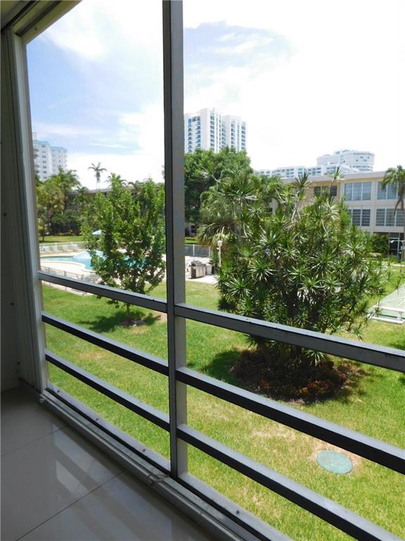 1481 South Ocean Boulevard, Unit 222B Pompano Beach, FL 33062 - Photo 15 of 28 a view of a glass door with a bench in front of it