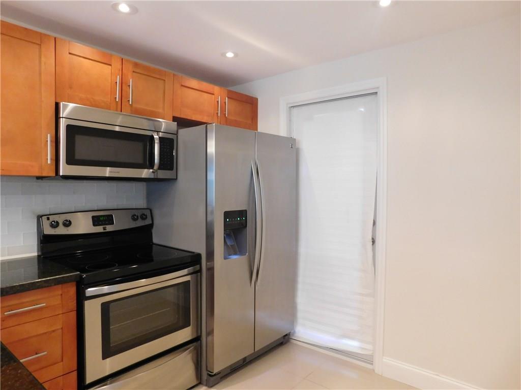1481 South Ocean Boulevard, Unit 222B Pompano Beach, FL 33062 - Photo 20 of 28 a kitchen with stainless steel appliances a stove a microwave and a sink