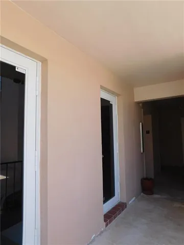 a view of hallway with wooden floor