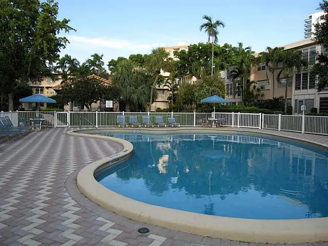 a view of a swimming pool with a yard