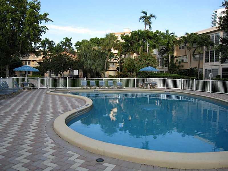 1481 South Ocean Boulevard, Unit 222B Pompano Beach, FL 33062 - Photo 6 of 28 a view of a swimming pool with a yard