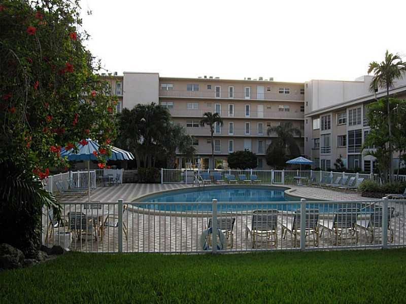 1481 South Ocean Boulevard, Unit 222B Pompano Beach, FL 33062 - Photo 7 of 28 a view of a large building with a yard