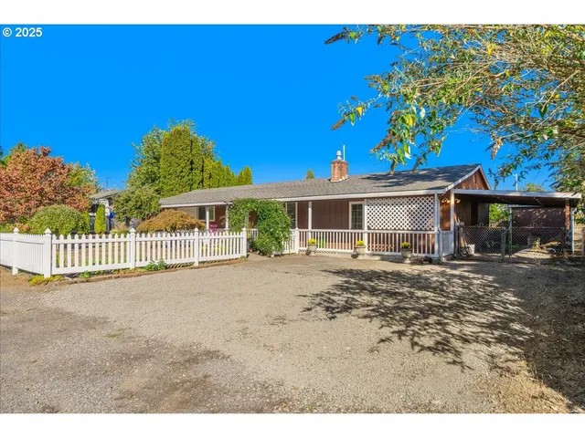 a view of a house with a yard and porch