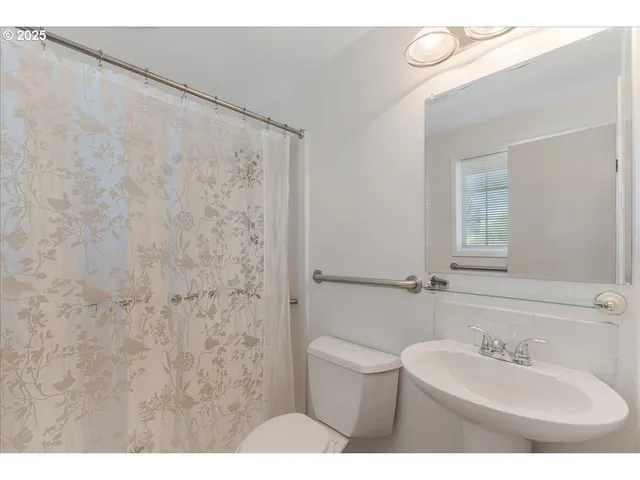 a bathroom with a sink a toilet and mirror