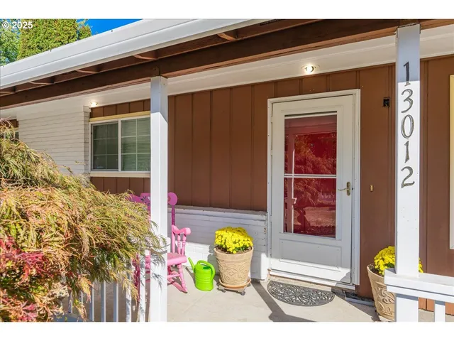 a front view of a house with outdoor seating and a potted plant