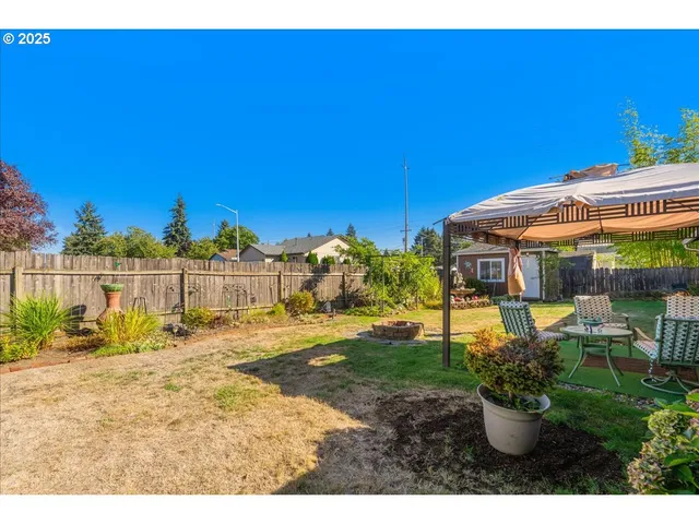 a view of a backyard with sitting area