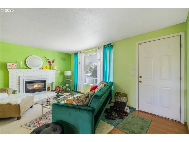 a living room with furniture and a fireplace