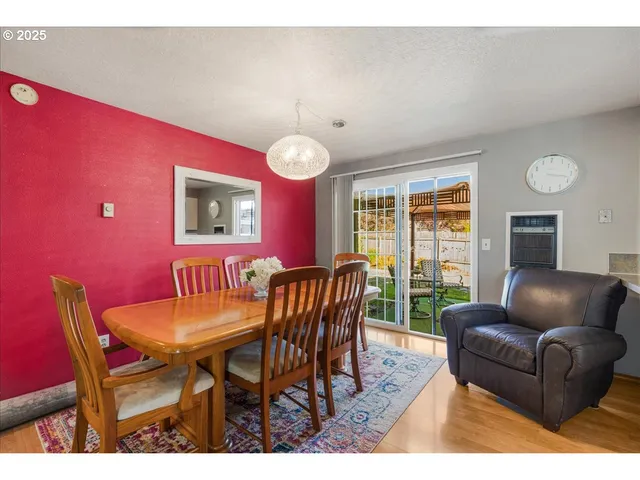 a view of a dining room with furniture and a large window