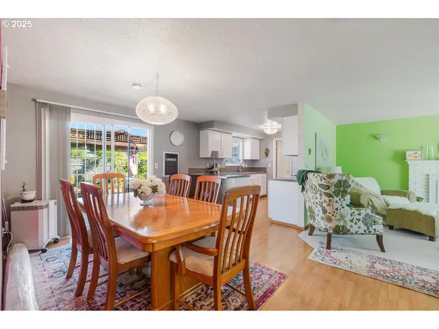 a view of a dining room with furniture and a large window