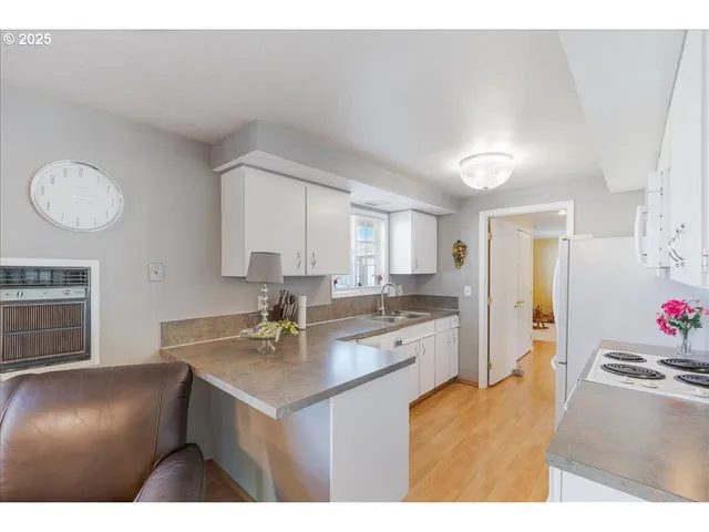 a kitchen with a sink cabinets and window