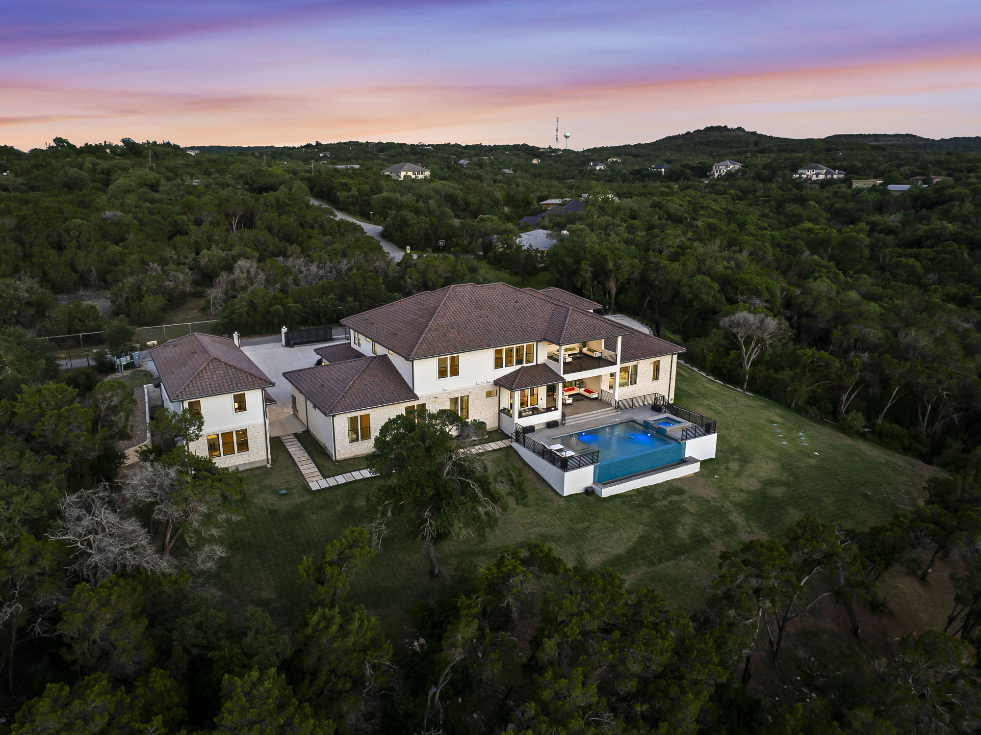 10211 Thistle Ridge Austin, TX 78733 - Photo 2 of 39 Aerial view at dusk of a wooded view