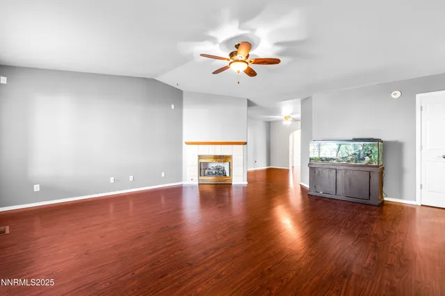 a kitchen with stainless steel appliances granite countertop a refrigerator a sink dishwasher a stove with wooden floor and cabinets