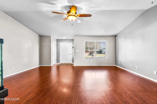 a view of a kitchen with wooden floor and a kitchen space with a sink