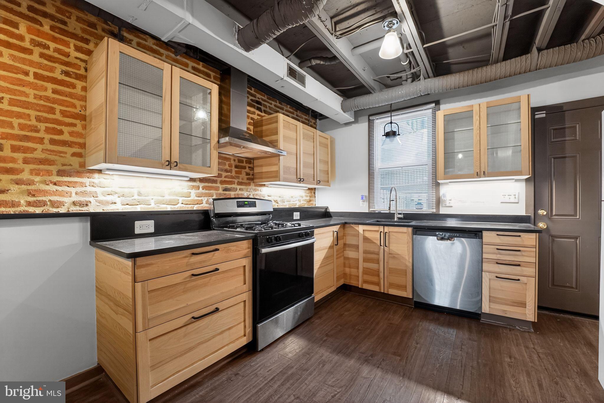 1602 Latrobe Street Baltimore, MD 21202 - Photo 8 of 15 Modern kitchen with rustic brick accents.