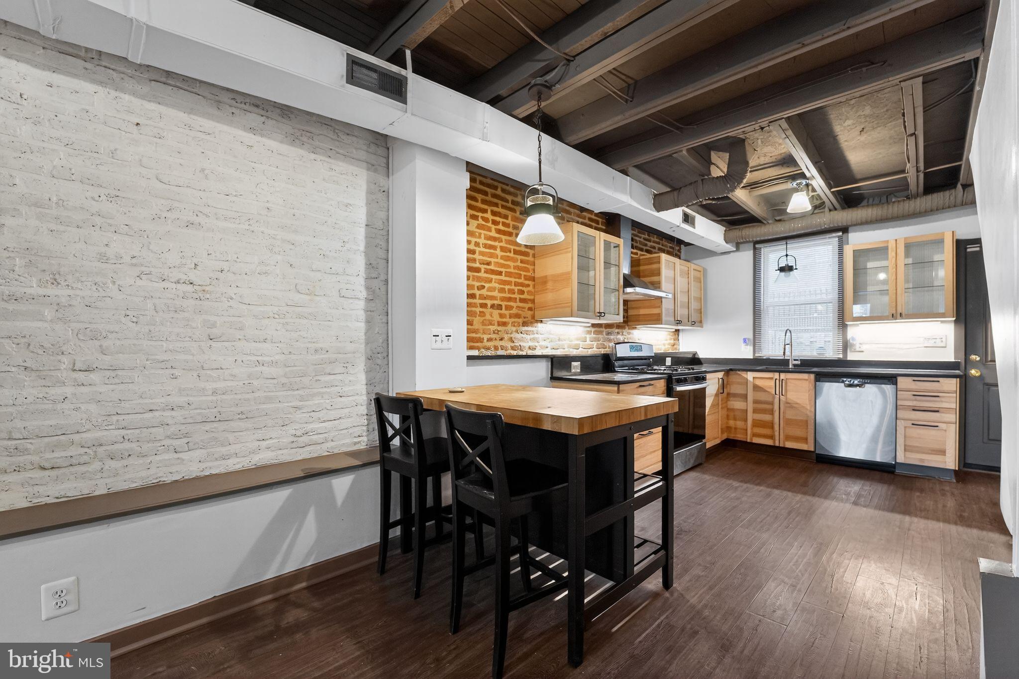 1602 Latrobe Street Baltimore, MD 21202 - Photo 10 of 15 Chic urban kitchen with exposed brick charm.