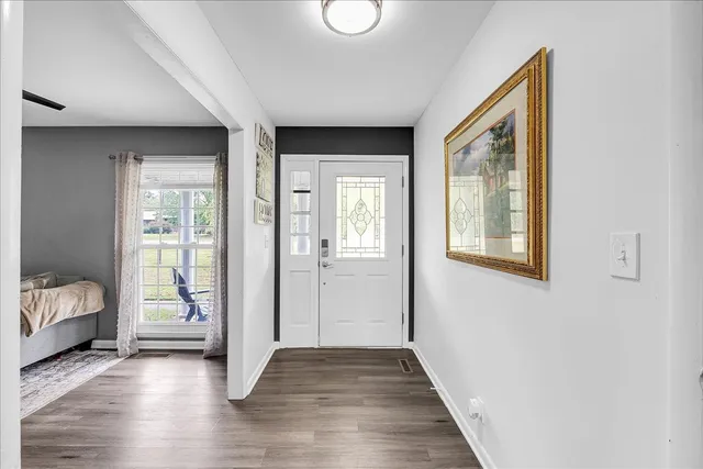 a view of room with hardwood floor and a ceiling fan
