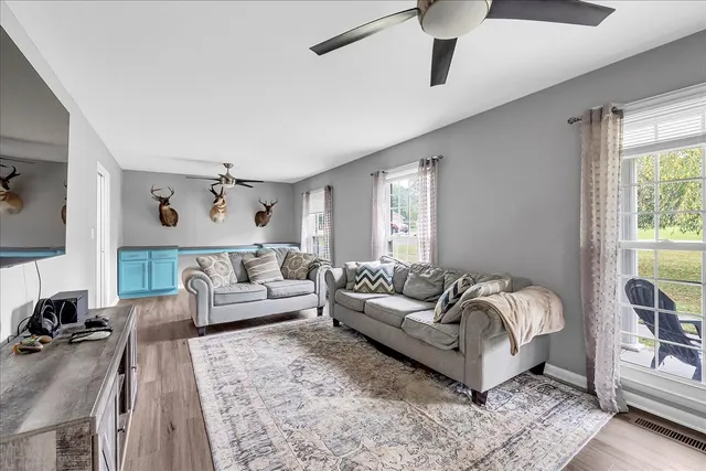a kitchen with a sink stove cabinets and wooden floor